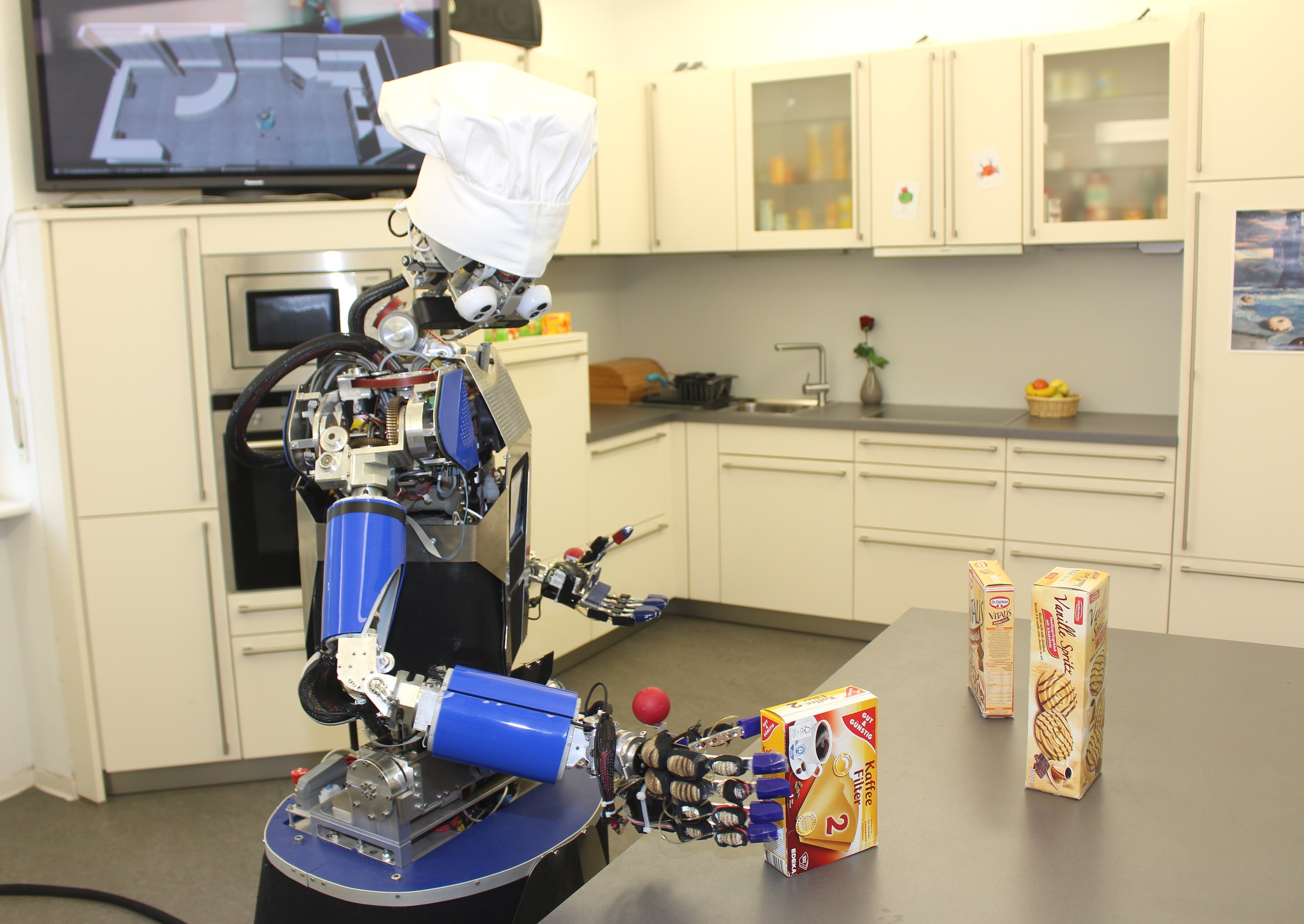 Die Ein-Mann-Robo-Küchenbrigade bestätigt die ihm gestellte Aufgabe und bewegt sich mittels omnidirektionaler Räder hin zum Tisch.