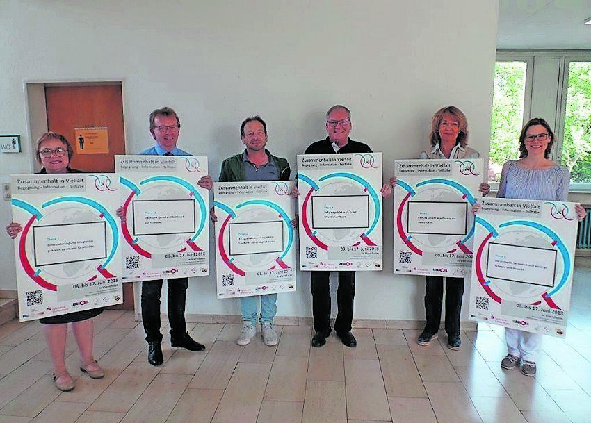 Bürgermeister Baaß und seine Mitstreiter präsentieren die Plakate zur Interkulturellen Woche.