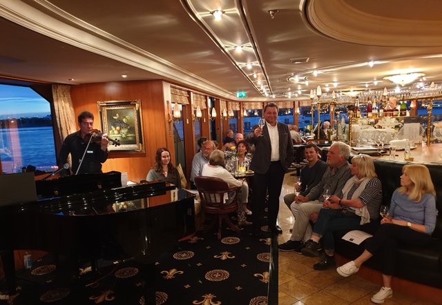 Weinkontor-Vertriebsleiter Ulrich Steuerwald (Mitte) führte durch die sechsteilige Weinprobe, Pianist, Sänger und Geiger Tony sorgte wie an allen Bordabenden für eine ansprechende musikalische Unterhaltung. | Foto: Harald Schönig 