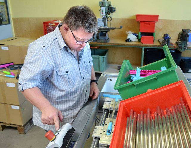 Per Knopfdruck verpresst Michael Kögel den sogenannten Hauptkörper und den Griff aus Kunststoff sowie ein Aluminiumrohr.  | Foto: Christmann/Lebenshilfe Südliche Weinstraße