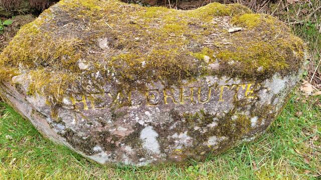 Ein verwitterter alter Sandstein im Ort mit der Inschrift "Hexlerhütte" verweist auf die Gründerzeit des Dorfes.
 | Foto: Markus Pacher