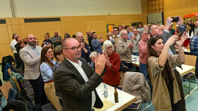 Nach der Bekanntgabe des Wahlergebnisses: Der amtierende Verbandsbürgermeister Dr. Peter Degenhardt (vorn) erhält stehenden Applaus. Direkt hinter ihm Stadtbürgermeister Mattia De Fazio unter den Gratulierenden. | Foto: Erik Stegner