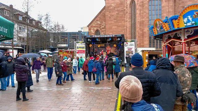 Live-Musik auf dem Alexanderplatz: Trotz Regen kamen zahlreiche Besucher zur Eröffnung des Zweibrücker Weihnachtsmarkts und sorgten für eine lebendige Atmosphäre vor der Bühne. | Foto: Norbert Scharf