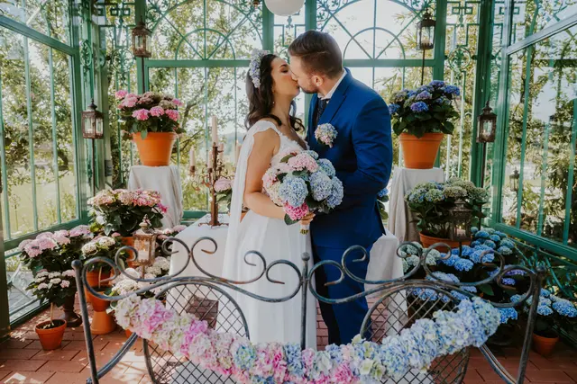 Beim Dekorieren für eine Sommerhochzeit helfen Topfhortensien, weil sie früh aufgestellt werden können und den Tag über stabil wirken. Besonders harmonisch wirkt ein Farbverlauf, wenn sich Rosa und Hellblau am Tisch wiederholen. | Foto: Magical Hydrangea/Anna Haslauer