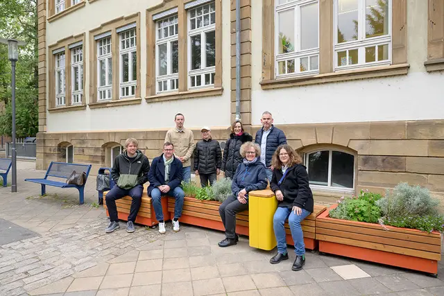Freude über die umgestaltete Wallstraße an der Fröbelschule in Wieblingen: Urs
Südhof (Amt für Stadtentwicklung und Stadtplanung, sitzend v.l.), Raoul
Schmidt-Lamontain (Bürgermeister für Klimaschutz, Umwelt und Mobilität), Antje
Spellig (Rektorin Fröbelschule) und Anne Stauffer (Elternbeiratsvorsitzende),
Timo Schmitz (Amt für Mobilität, stehend v.l.), Michael Sauerzapf (Amt für
Stadtentwicklung und Stadtplanung), Bärbel Sauer (Leiterin Amt für Mobilität),
Thorsten Röver (Kinderbeauftragter Wieblingen). (Foto: Philipp Rothe) | Foto: Stadt Heidelberg