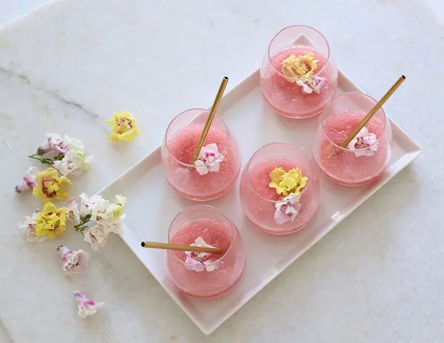 Der Tee-Frosé ist ein Mix von Cold Brew Tea und alkoholfreiem Roséwein und wird am besten mit essbaren Blüten dekoriert. (zu dpa: «Soooo fruchtig und slushy: Tee-Frosé macht heiße Nächte cool») | Foto: dpa