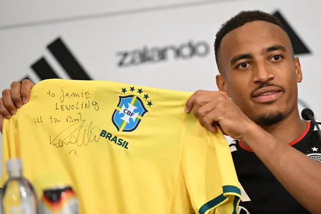 Jamie Leweling zeigt das Brasilien-Trikot mit der Unterschrift von Ronaldo.  | Foto: Federico Gambarini/dpa
